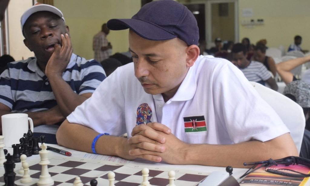 Mehul Gohil in action during the 2019 Mombasa Open while John Mukabi looks onPhoto credit Mombasa Chess Club.