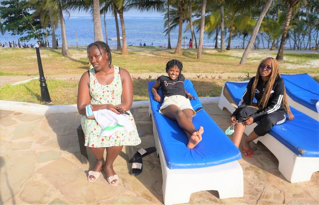 The reason why the Mombasa Open is so popular - the sun, sand and the coconut trees. From left WCM Joyce Nyaruai, Julie Mutisya and Glenda Madelta enjoying their free time.