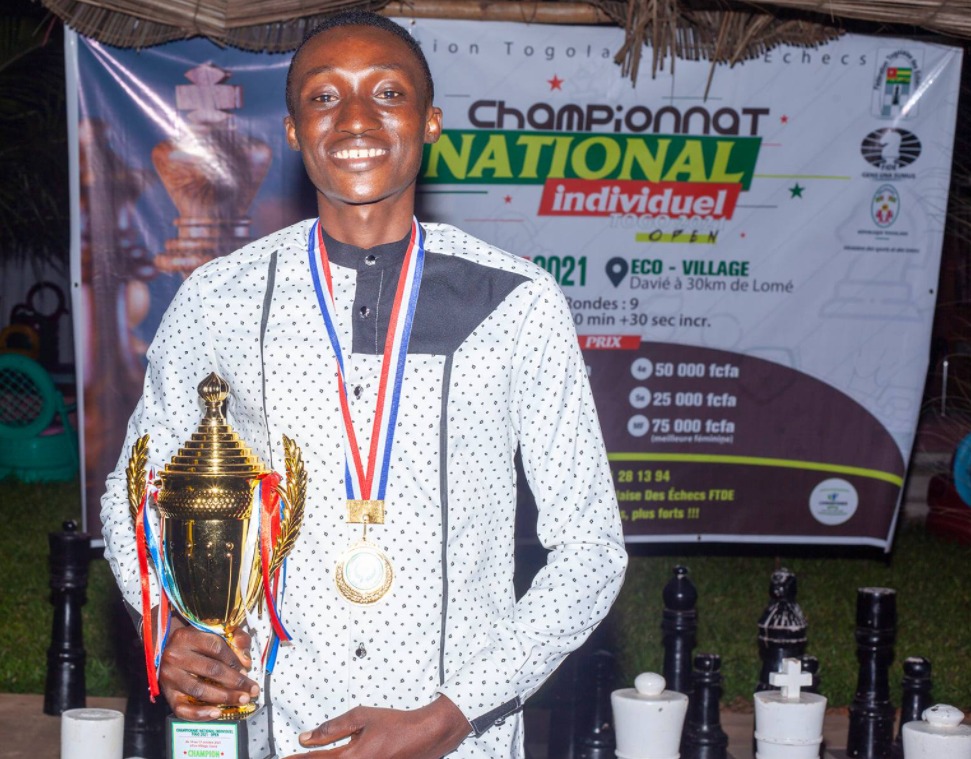 Ballebako Kokou Difendramakada Jacques the 2021 Togo National Chess Champion poses with his trophy.