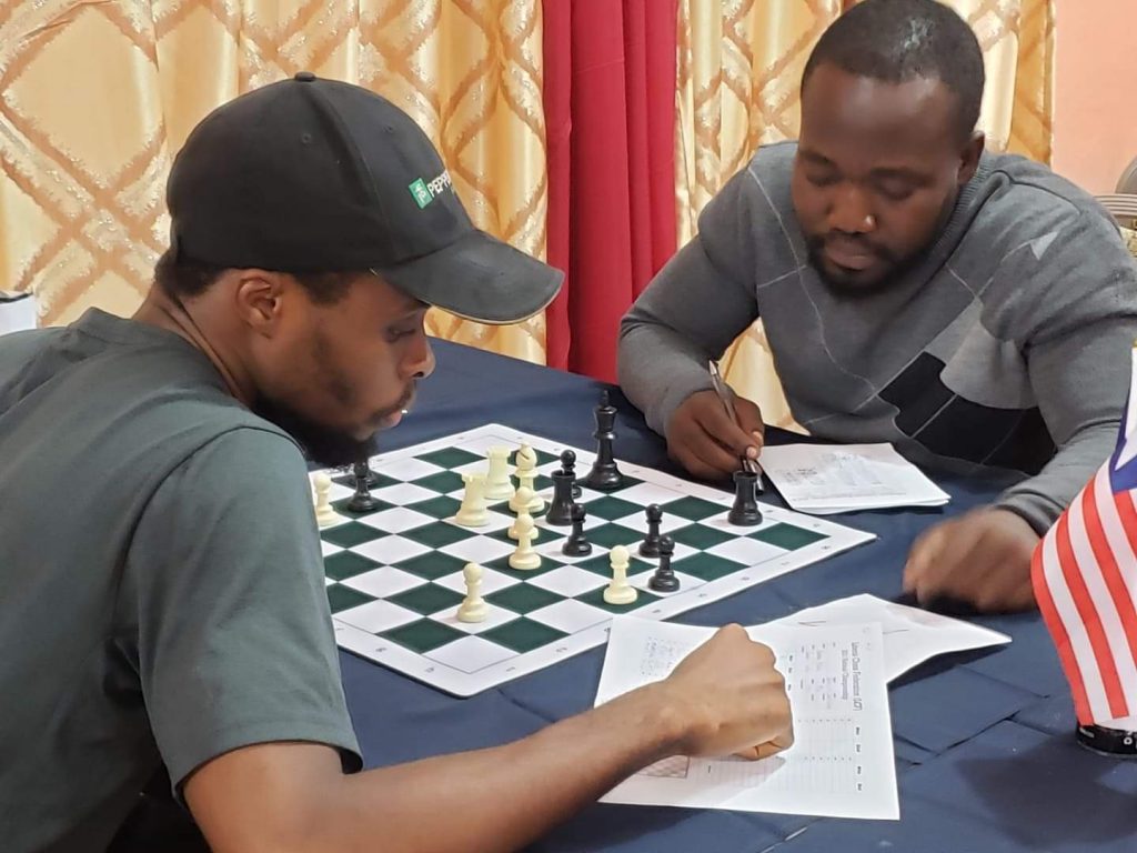 Bobby Ballah (left) reviewing their game after round 7.