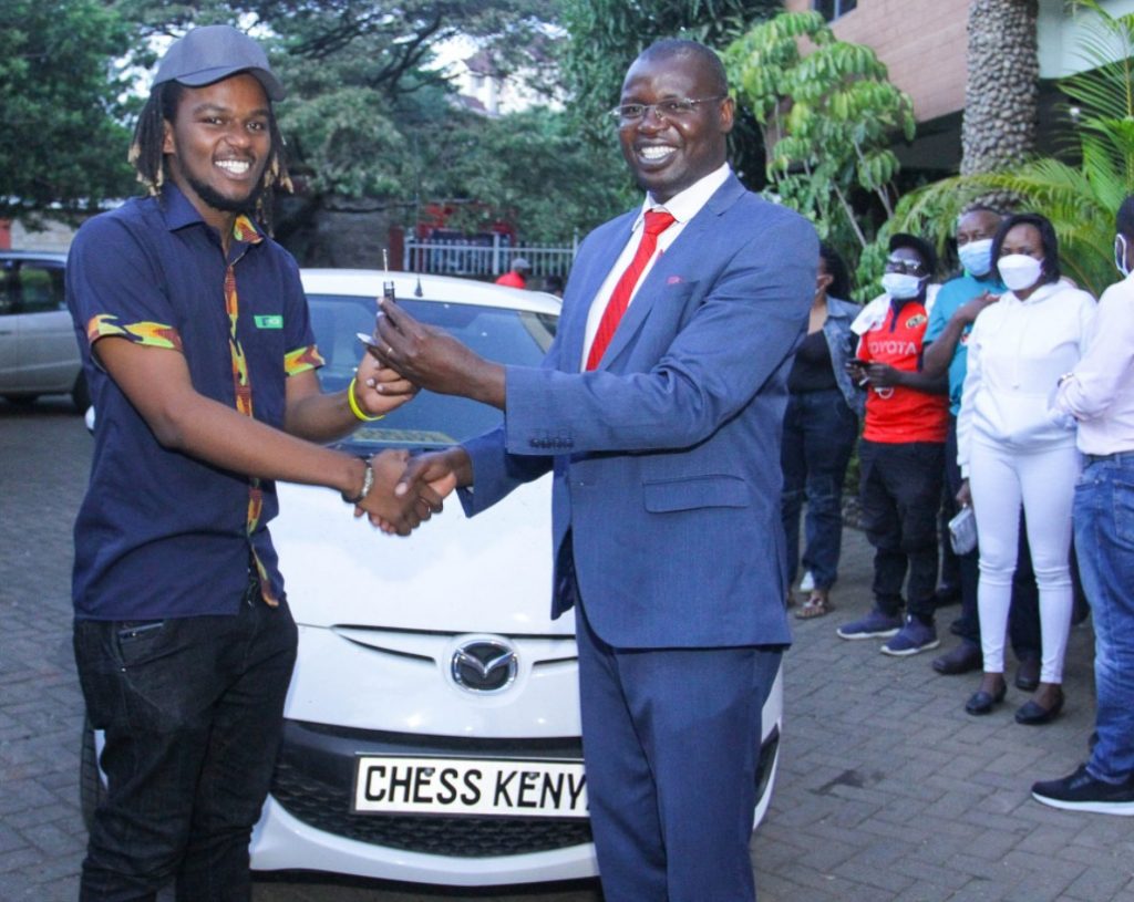 Chess Champion – Martin Njoroge receives the keys to the car that he won. Photo credit Oliver Ananda .