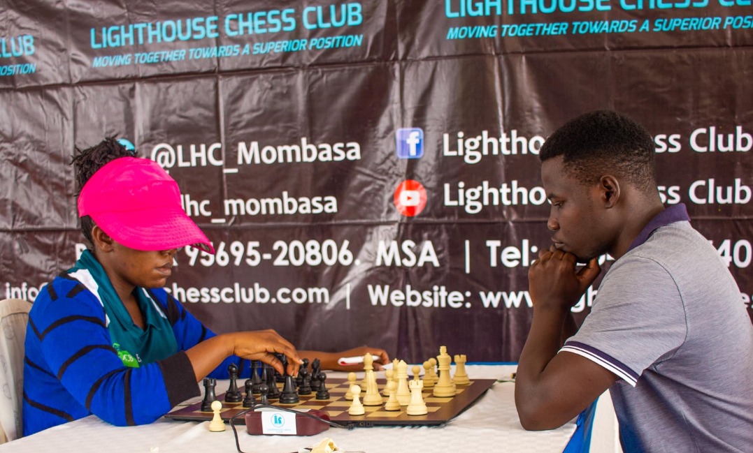Gloria Jumba (left) in her first round game which ended in a draw against Emmanuel Egesa of Uganda.