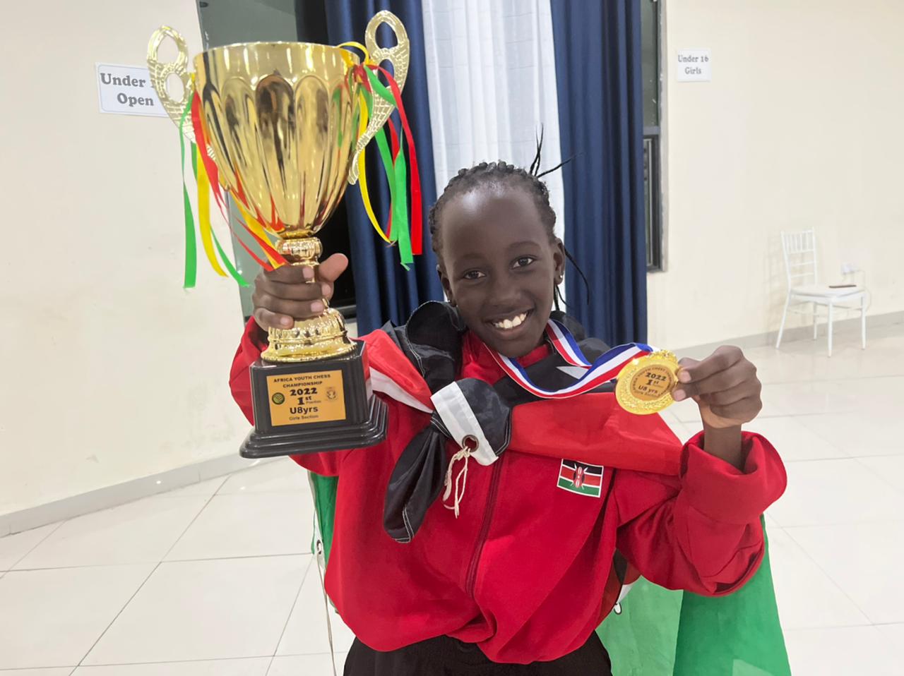 Winnie Kaburo poses with the winners trophy.
