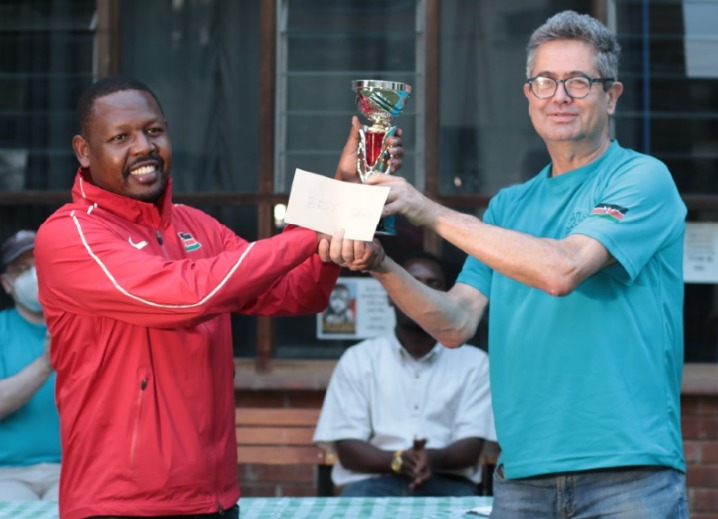 Ricky Sang (left) receives his trophy from Willy Simons the Chairman of Nairobi Chess Club.