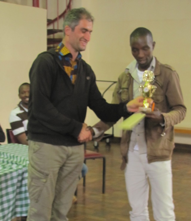 Mushfig Habilov the Director or Play at Nairobi Chess Club (left) presents Jackson Ndegwa Kamau with his prize.