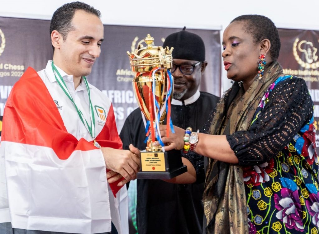 The 2022 African Individual Chess Champion GM Bassem Amin receives his prize from ACC President Ms Tshepiso Lopang,.