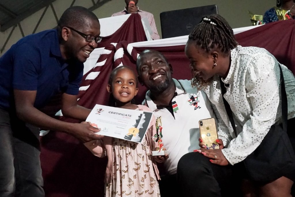 6 year old Arielo Telo receives her prize with her proud dad Dr Victor Ng'ani (in white shirt).