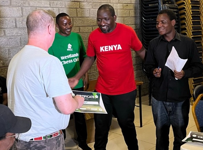 James Arthur Todd (left) presents Dr Victor Ng'ani with his prize while Collins Young (green shirt) and IA Duke Michieka looks on.