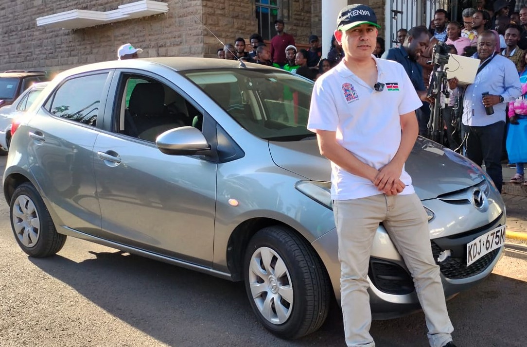 Mehul Gohil aka 'Gorilla' the proud winner of the 2022 Kenya National Chess Championship posing with the car that he won as the first prize. Photo credit Kim Bhari.