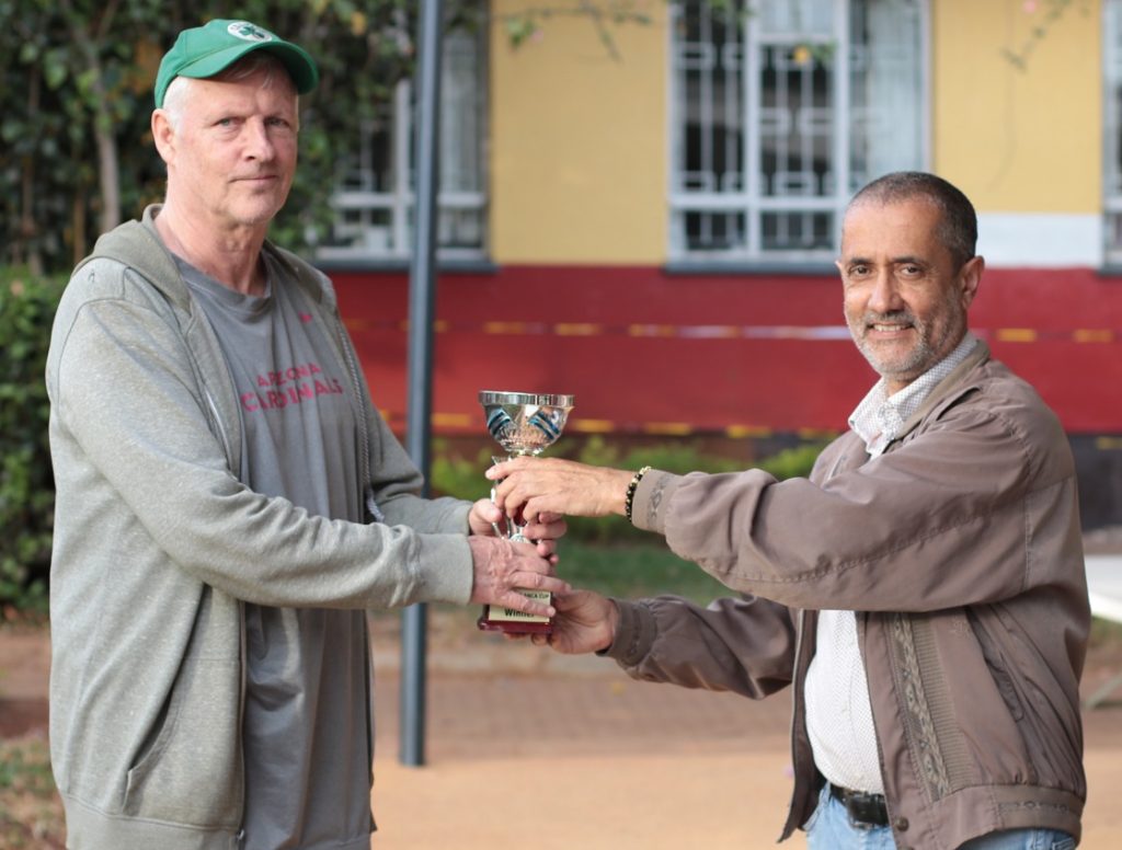 Peter Gilruth receives his trophy for winning the 12th Capablanca Cup from Kim Bhari the tournament director of the event.