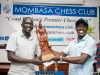 Peter Majur Manyang of South Sudan (left) receives the floating trophy from Mombasa Chess Club Chairman Paul Ryan. Photo credit Mombasa Chess Club.