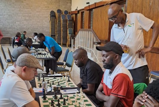 Mehul Gohil (left) faces Moses Andiwoh in their round 4 encounter while Matthew Kanegeni observes the board. Photo credit Cynthia Kyalo.