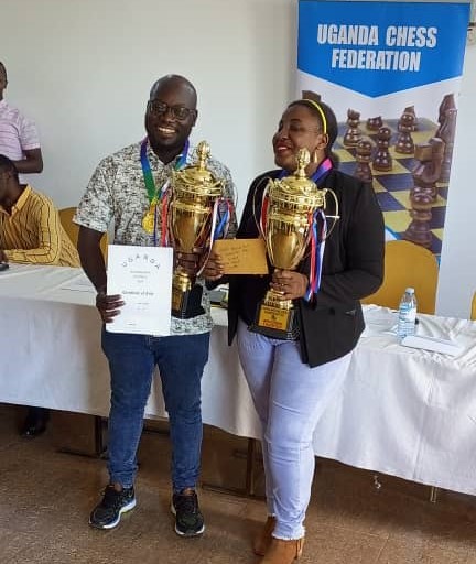IM Arthur Ssegwanyi and WCM Shakira Ampaire pose with their trophies.