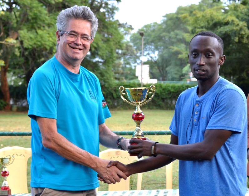 Nairobi Chess Club Chairman Willy Simons (left) presents Brian Gabriel Mwangi the trophy for winning the Open section of the 6th Le Pelley Tournament.