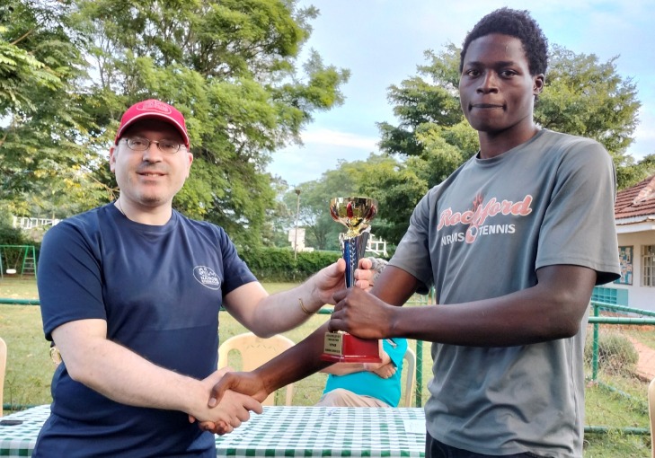 Nairobi Chess Club Committee Member Warren Pollock (left) presents Ezekiel Karani with his trophy for winning the U1800 Section.